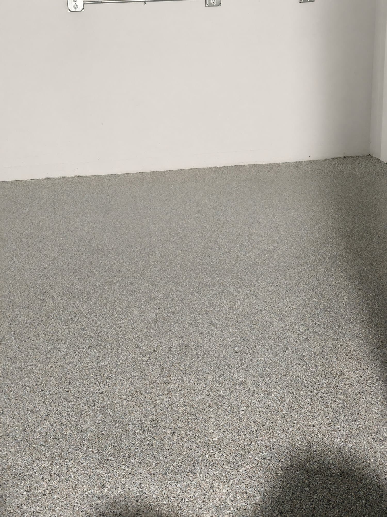 Tan and gray flake epoxy floor in a garage corner