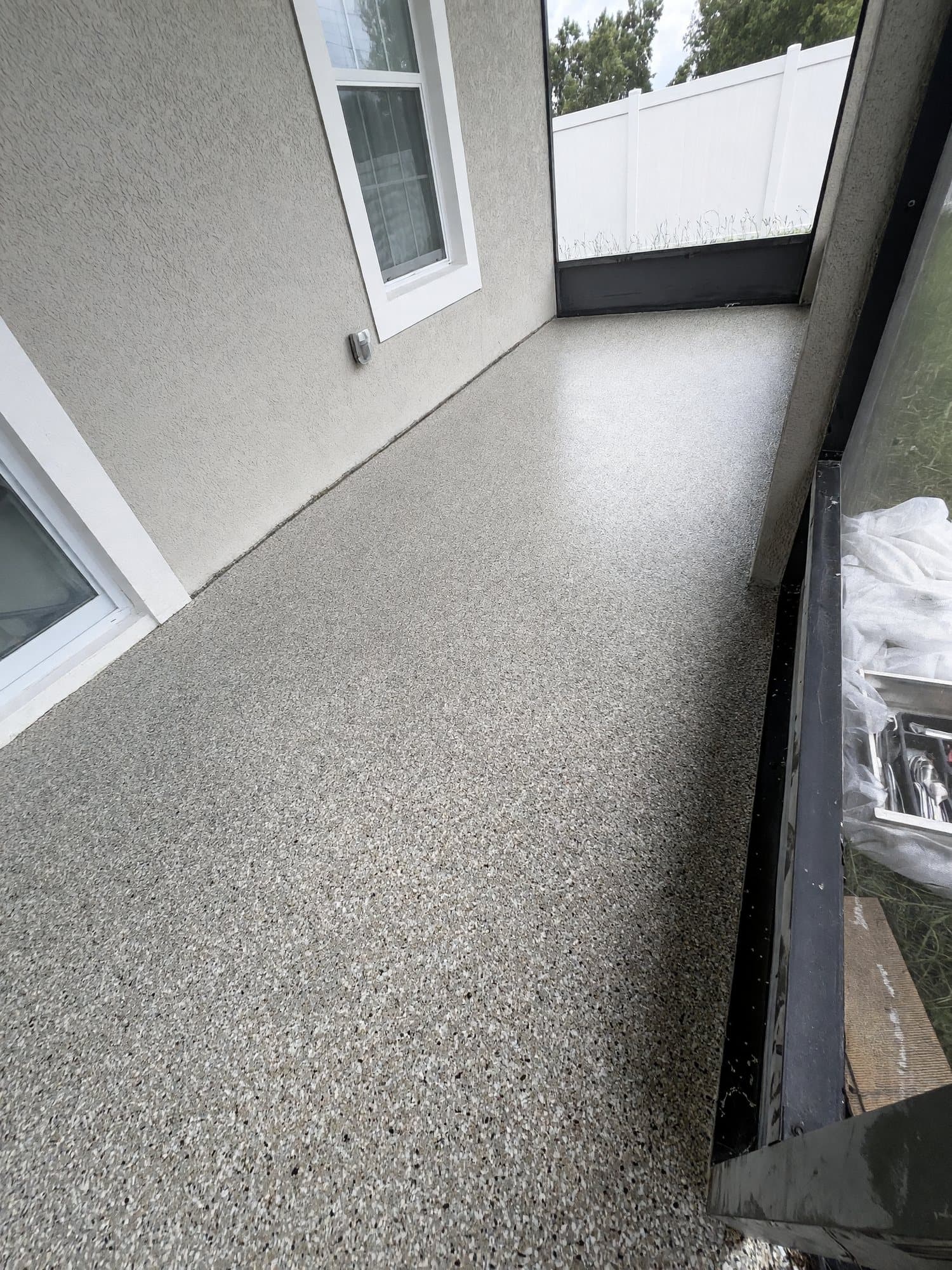 Gray-tan flake epoxy floor on a screened lanai